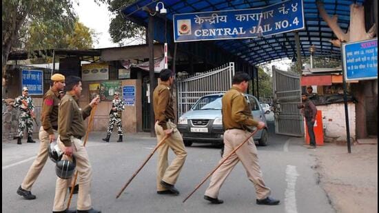 Security personnel stand guard outside at a gate of Tihar Jail. (PTI)