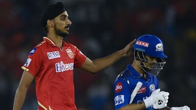 Arshdeep Singh greets Ishan Kishan during the IPL match between Punjab Kings and Mumbai Indians at the PCA Stadium in Mohali (AFP)