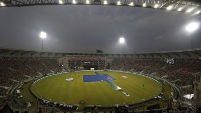 The pitch area is seen covered with plastic sheets after rain stopped play during a match. (AP) The pitch area is seen covered with plastic sheets after rain stopped play during a match. (AP)