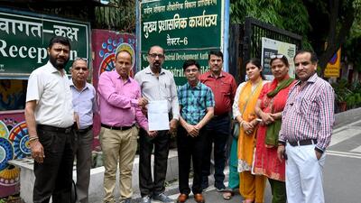 Parents of students at Uttarakhand Public School with the Noida authority order. (Sunil Ghosh/HT Photo)