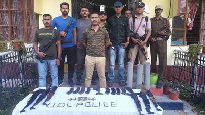 Police personnel with the illegal arms recovered during the operation. (HT Photo)