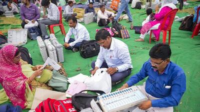 Polling officials collect EVMs and other voting materials at a distribution centre ahead of the urban local bodies’ elections, in Lucknow on Wednesday. (PTI PHOTO) Polling officials collect EVMs and other voting materials at a distribution centre ahead of the urban local bodies’ elections, in Lucknow on Wednesday. (PTI PHOTO)