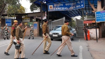 Security personnel stand guard outside at a gate of Tihar Jail. (PTI) (HT_PRINT)