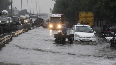 Vehicles wade through a waterlogged stretch between Khandsa to Narsingpur village in rain on the NH-48 service road near Shani Mandir, in Gurugram on Wednesday. (Parveen Kumar/HT)