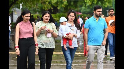 Visitors enjoying the rainy weather at Sukhna Lake in Chandigarh on Wednesday. (Keshav Singh/HT)