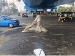 Mumbai traffic police spreading sand on the road. Mumbai traffic police spreading sand on the road.