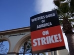 A Writers Guild of America sign at a picket line outside Paramount Studios in Los Angeles, California, US, on Wednesday, May 3, 2023. Photographer: Eric Thayer/Bloomberg A Writers Guild of America sign at a picket line outside Paramount Studios in Los Angeles, California, US, on Wednesday, May 3, 2023. Photographer: Eric Thayer/Bloomberg