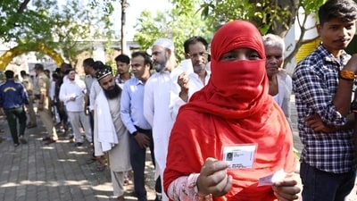 Voters display their ID cards, as they wait in a queue to cast their vote at Mallhaur polling center. (Deepak Gupta / Hindustan Times) Voters display their ID cards, as they wait in a queue to cast their vote at Mallhaur polling center. (Deepak Gupta / Hindustan Times)