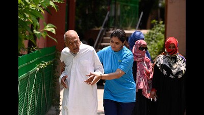A girl accompanied with her grandfather to the polling booth. (Deepa Gupta)