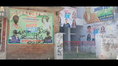 A poster of Congress general secretary Kumari Selja and others blackened at the Congress Bhawan in Ambala City. (HT Photo)