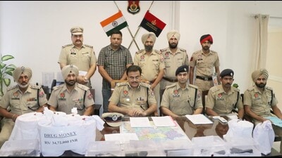 Cops with seized weapons and drug money.