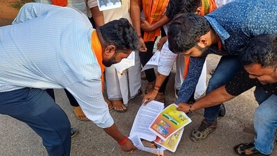 Bajrang Dal workers burn copies of Karnataka Congress manifesto during a protest. (PTI) Bajrang Dal workers burn copies of Karnataka Congress manifesto during a protest. (PTI)