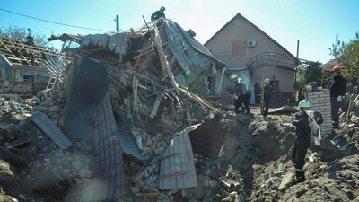 Rescuers work at the site of a residential area heavily damaged by a Russian missile strike, amid Russia's attack on Ukraine, in Zaporizhzhia, Ukraine. (REUTERS)