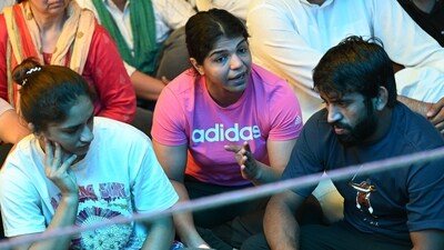 Indian wrestlers Vinesh Phogat (L), Sakshi Malik (C) and Bajrang Punia (R) take part in an ongoing protest with other wrestlers against the Wrestling Federation of India (WFI), in New Delhi on April 4, 2023. (AFP) Indian wrestlers Vinesh Phogat (L), Sakshi Malik (C) and Bajrang Punia (R) take part in an ongoing protest with other wrestlers against the Wrestling Federation of India (WFI), in New Delhi on April 4, 2023. (AFP)
