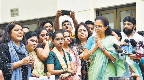 Nationalist Congress Party (NCP) leader Supriya Sule tries to pacify as she interacts with party workers and supporters during their 'dharna' urging Pawar to withdraw his resignation. (HT PHOTO)