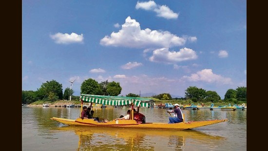 Visitors enjoying the pleasant weather with boating at Sukhna Lake in Chandigarh. (Keshav Singh/HT)