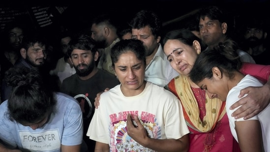 Wrestlers speak with the media after a scuffle allegedly broke out between protesting wrestlers and the police at Jantar Mantar, in New Delhi, late Wednesday, May 3, 2023. (PTI)