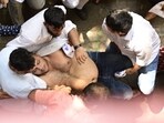 An NCP worker is being rescued as he tried to die by suicide outside the party office in Mumbai. (Anshuman Poyrekar/HT) An NCP worker is being rescued as he tried to die by suicide outside the party office in Mumbai. (Anshuman Poyrekar/HT)