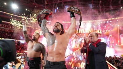 Roman Reigns, (center), holds up his WWE heavyweight and universal championship belts after defeating Cody Rhodes in the main event of WrestleMania 39, (AP) Roman Reigns, (center), holds up his WWE heavyweight and universal championship belts after defeating Cody Rhodes in the main event of WrestleMania 39, (AP)