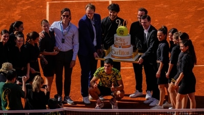 Carlos Alcaraz, of Spain, center down, poses with a cake for his 20th birthday after his victory over Borna Coric (AP) Carlos Alcaraz, of Spain, center down, poses with a cake for his 20th birthday after his victory over Borna Coric (AP)