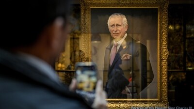 King Charles Coronation: A man takes a picture of a portrait of King Charles III painted by Alastair Barford, in London. (AP) King Charles Coronation: A man takes a picture of a portrait of King Charles III painted by Alastair Barford, in London. (AP)