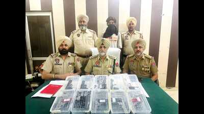 Police have impounded a motorcycle and recovered a bag containing 10 pistols . (HT Photo) Police have impounded a motorcycle and recovered a bag containing 10 pistols . (HT Photo)