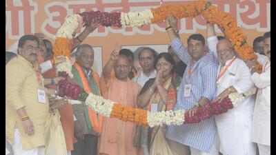 Uttar Pradesh chief minister Yogi Adityanath flanked by Ghaziabad MP VK Singh and BJP mayoral candidate Sunita Dayal during an election rally at Kavi Nagar Ramlila Maidan in Ghaziabad. (Sakib Ali/HT Photo) Uttar Pradesh chief minister Yogi Adityanath flanked by Ghaziabad MP VK Singh and BJP mayoral candidate Sunita Dayal during an election rally at Kavi Nagar Ramlila Maidan in Ghaziabad. (Sakib Ali/HT Photo)