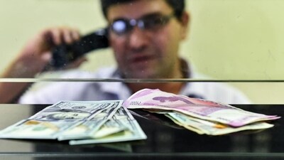 Currency seen at a forex bureau counter in New Delhi. (PTI Photo) Currency seen at a forex bureau counter in New Delhi. (PTI Photo)