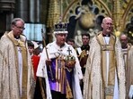 Britain's King Charles III wearing the Imperial state Crown carrying the Sovereign's Orb and Sceptre leaves Westminster Abbey after the Coronation. 