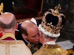 Prince William kisses his father King Charles III during his coronation ceremony at Westminster Abbey in London, Saturday May 6, 2023.