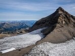 This aerial picture taken on September 13, 2022 at Glacier 3000 resort above Les Diablerets shows the Tsanfleuron pass free of the ice that covered it for at least 2,000 years next to blankets (L) covering snow from the last winter season to prevent it from melting. This aerial picture taken on September 13, 2022 at Glacier 3000 resort above Les Diablerets shows the Tsanfleuron pass free of the ice that covered it for at least 2,000 years next to blankets (L) covering snow from the last winter season to prevent it from melting.