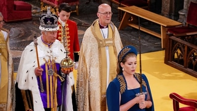 Lord President of the Council, Penny Mordaunt, holding the Sword of State walking ahead of King Charles III during his coronation ceremony in Westminster Abbey, London. Picture date: Saturday May 6, 2023. (via REUTERS)