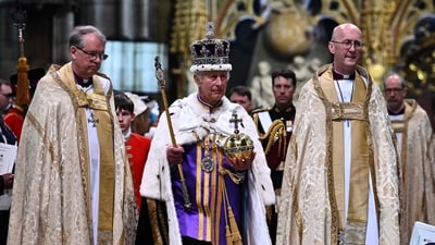 Britain's King Charles III wearing the Imperial state Crown carrying the Sovereign's Orb and Sceptre leaves Westminster Abbey after the Coronation. (AFP)