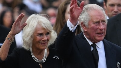 Britain's King Charles III (R) and Britain's Camilla, Queen Consort wave as they greet the crowd. (AFP) Britain's King Charles III (R) and Britain's Camilla, Queen Consort wave as they greet the crowd. (AFP)