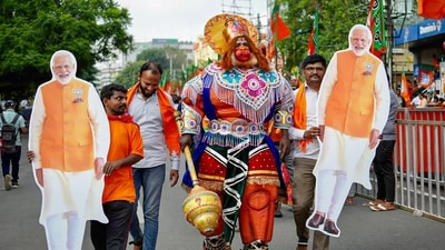 A supporter dressed as Lord Hanuman during a road show of Prime Minister Narendra Modi ahead of Karnataka Assembly elections, in Bengaluru on Saturday. (PTI) A supporter dressed as Lord Hanuman during a road show of Prime Minister Narendra Modi ahead of Karnataka Assembly elections, in Bengaluru on Saturday. (PTI)