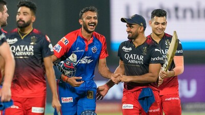 Delhi Capitals batter Axar Patel exchanges greetings with RCB players (PTI) Delhi Capitals batter Axar Patel exchanges greetings with RCB players (PTI)