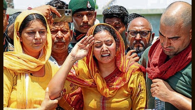 The wife of havildar Neelam Singh saluting his mortal remains at their residence in Akhnoor, Jammu and Kashmir. (PTI) The wife of havildar Neelam Singh saluting his mortal remains at their residence in Akhnoor, Jammu and Kashmir. (PTI)