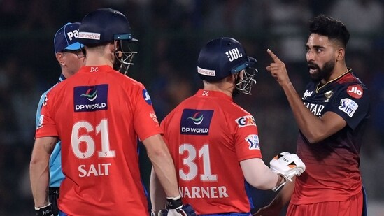 Mohammed Siraj gestures towards Phil Salt during the IPL match between Delhi Capitals and Royal Challengers Bangalore at the Arun Jaitley Stadium in New Delhi(AFP)