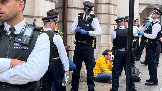 King Charles coronation: A photo posted on Twitter showed Smith sitting on the ground surrounded by a group of police officers. (Twitter/ @RepublicStaff)