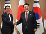 South Korean President Yoon Suk Yeol (R) shakes hands with Japanese Prime Minister Fumio Kishida. South Korean President Yoon Suk Yeol (R) shakes hands with Japanese Prime Minister Fumio Kishida.
