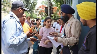 A student during security check outside a NEET-UG exam centre. (Manish/Ht) A student during security check outside a NEET-UG exam centre. (Manish/Ht)
