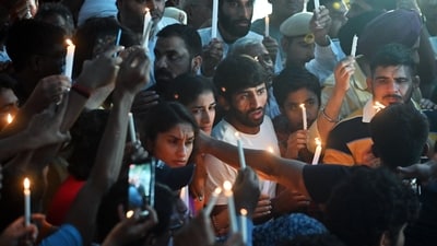 New Delhi, May 07 (ANI): Wrestlers Bajrang Punia, Vinesh Phogat, Sangeeta Phogat, and others during a candle march in view of wrestlers' protest against the alleged sexual harassment of players by WFI chief and BJP MP Brij Bhushan Sharan Singh at Jantar Mantar, in New Delhi on Sunday. (ANI photo) (Sanjay Sharma)