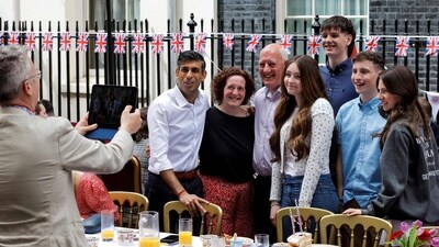 Britain's Prime Minister Rishi Sunak (rear L) poses for pictures with guests during a Coronation Big Lunch organised in Downing Street, in London, on May 7. (AFP)