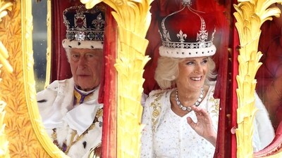 Britain's King Charles and Queen Camilla travel from Westminster Abbey in the Gold State Coach, following their coronation ceremony, in London, Britain, on Saturday. (Reuters)