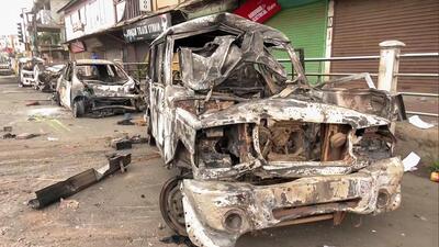 Charred remains of a vehicle are seen on a street, days after violent clashes in Manipur, in Imphal, India on Friday. (ANI) Charred remains of a vehicle are seen on a street, days after violent clashes in Manipur, in Imphal, India on Friday. (ANI)
