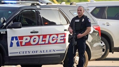 A law enforcement officer guards the entrance to a shopping center after a shooting Saturday. (AP)
