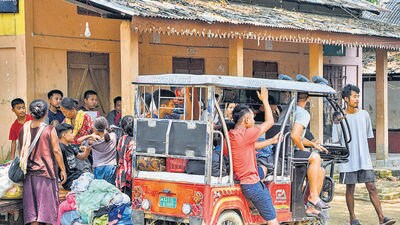 People from violence-hit areas of Manipur being shifted to a relief camp set up by the Assam government, in Cachar district, on Sunday. (PTI)