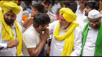 Wrestler Bajrang Punia with BKU(Ekta Ugrahan) chief Joginder Singh Ugrahan at Jantar Mantar in New Delhi on Sunday. (PTI)