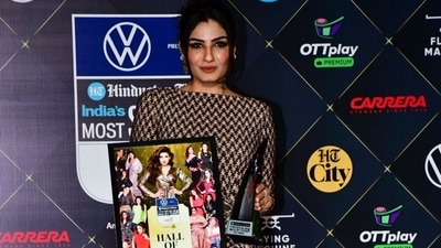 Actor Raveena Tandon wore a beige and black printed bodycon dress at the event. She fetched the Style Hall of Fame – Female award and also present an award to Akshay Kumar. (HT photos) Actor Raveena Tandon wore a beige and black printed bodycon dress at the event. She fetched the Style Hall of Fame – Female award and also present an award to Akshay Kumar. (HT photos)