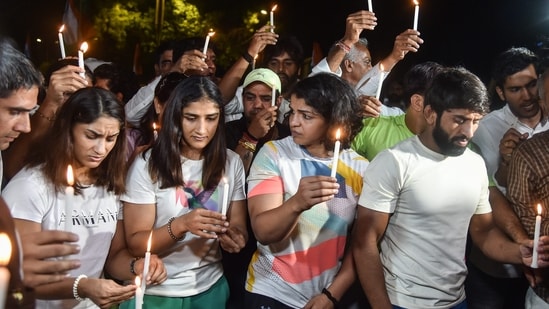 Wrestlers Bajrang Punia, Vinesh Phogat, Sakshi Malik and others participate in a candle march during their protest at Jantar Mantar Wrestlers Bajrang Punia, Vinesh Phogat, Sakshi Malik and others participate in a candle march during their protest at Jantar Mantar